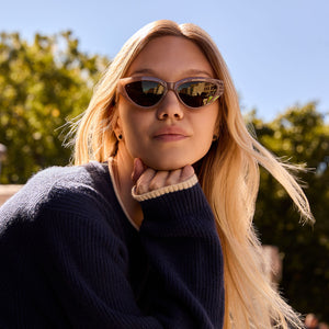 on model - blonde female wearing les do makeup x dime optics featuring last call cat eye sunglasses with a milky nude frame and brown with gold flash polarized lenses front view