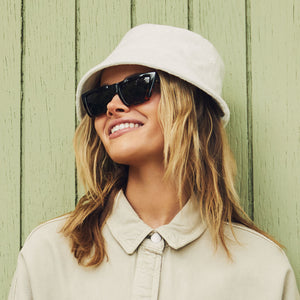 on model - blonde female wearing melrose with a black and tortoise frame and grey lenses sunglasses angled view