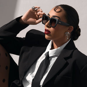 on model - rissa g wearing rissa g x dime optics she's a 10 square sunglasses with a glossy black frame with a dusk polarized lenses side view