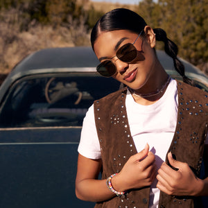 on model - female wearing dime optics roxbury round sunglasses with a gold metal frame and g15 polarized lenses front view