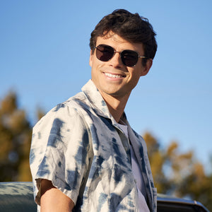 on model - male wearing dime optics roxbury round sunglasses with a gold metal frame and g15 polarized lenses front view