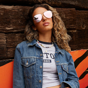 on model - female wearing dime optics abbot aviator sunglasses with a shiny gold frame and champagne mirror polarized lenses front view