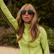 on model - female wearing dime optics encino aviator sunglasses with a chocolate brown metal frame and brown gradient polarized lenses front view