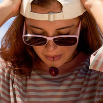 on model - female wearing dime optics featuring the agoura rectangular sunglasses with a candy heart pink frame and brown lenses front view