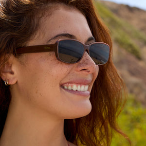 on model - female wearing dime optics featuring the agoura rectangular sunglasses with a mocha frame and brown lenses angled view