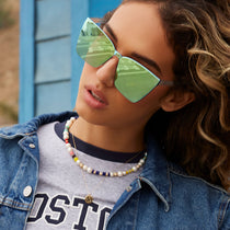 on model - female wearing dime optics glendale cat eye sunglasses with a crystal clear frame and cyan mirror lenses front view