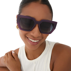 on model - female wearing rissa g x dime optics she's a 10 square sunglasses with a amethyst purple frame and grey gradient polarized lenses front view
