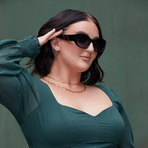 on model - Mikayla Jane x dime optics wearing the powerhouse black frame with grey gradient polarized sunglasses and a green dress